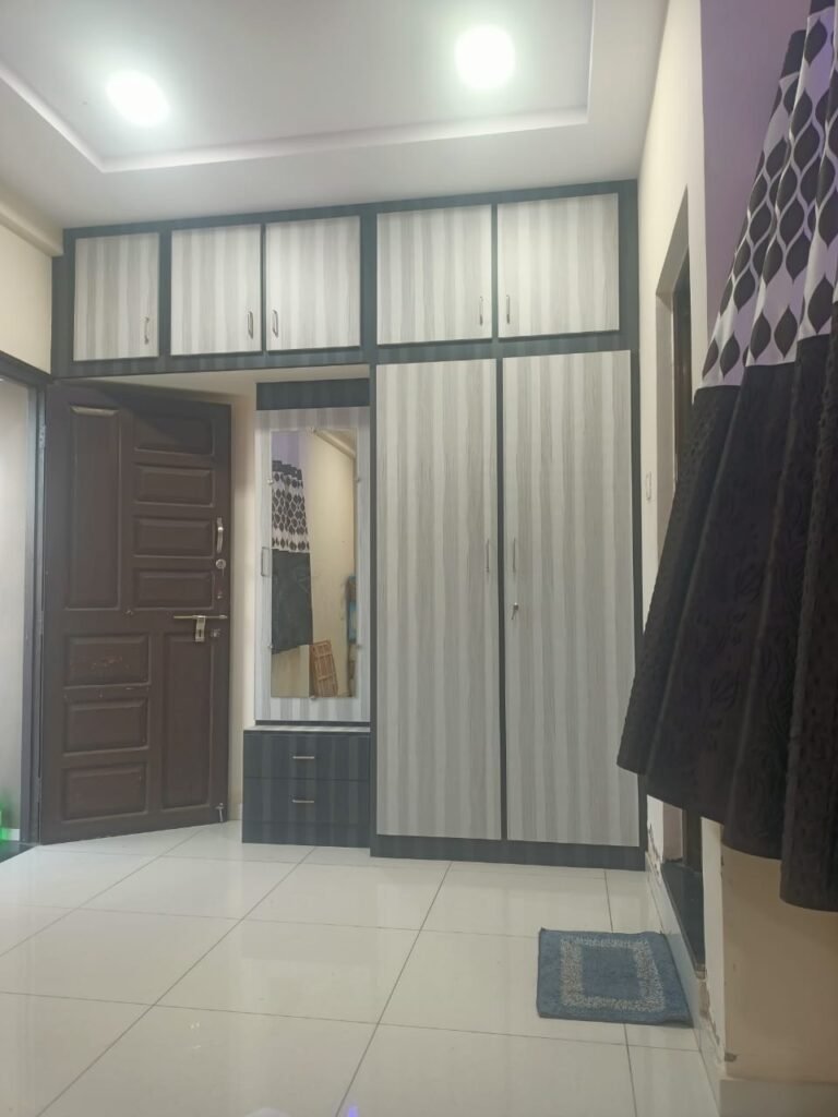 Wardrobe and storage space in a Shiv Homestay room